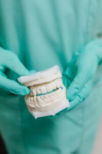 Person holding cheek, possibly experiencing tooth pain.