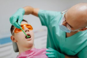 Patient lying on dental chair with calm expression.