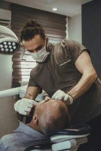 Dentist preparing equipment in a dental office setting
