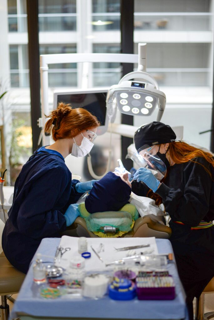 Dentists performing a procedure on a patient in a clinic.