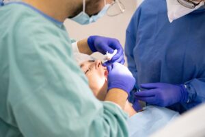Dentists performing a procedure on a patient in a clinic.