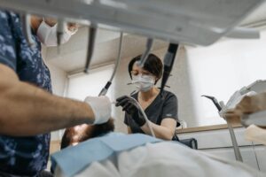 Dentists performing a procedure on a patient.