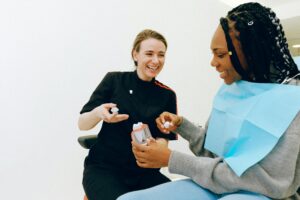 Dentist and patient smiling during a dental consultation.