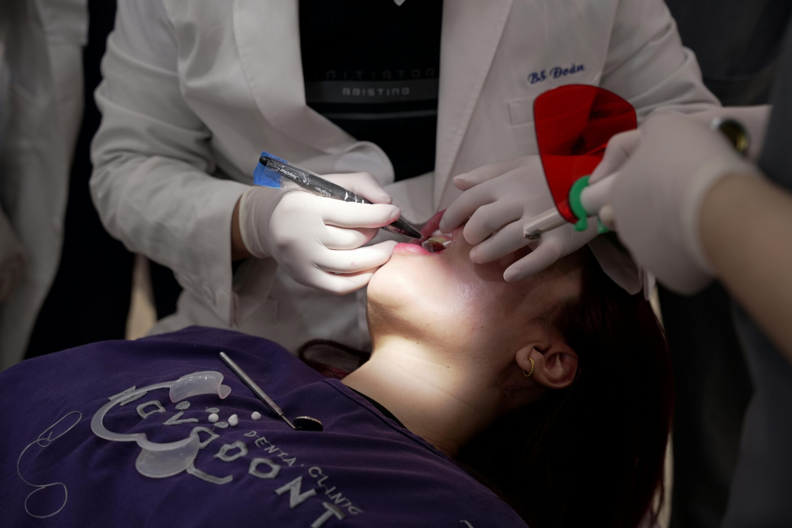 Dentist using Tofflemire matrix on a patient during a procedure.